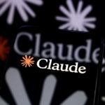 Smartphone displaying the Claude app logo with the orange Anthropic starburst icon on a black background