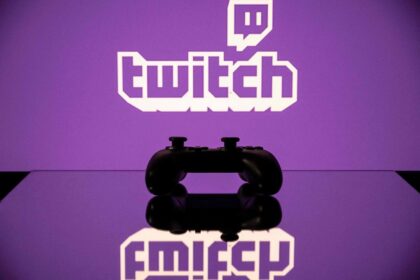 Twitch logo glowing on a screen above a game controller in purple light