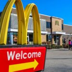 McDonald's restaurant exterior sign with golden arches at dusk