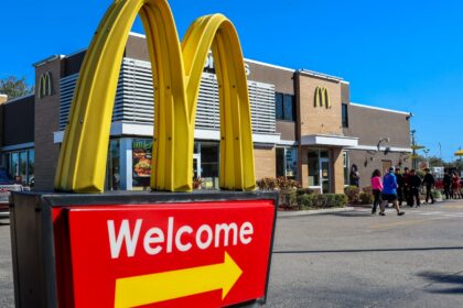 McDonald's restaurant exterior sign with golden arches at dusk