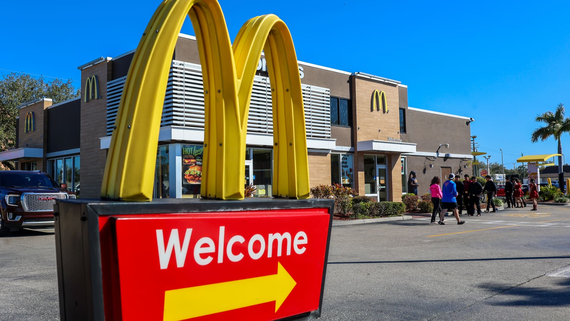 McDonald's restaurant exterior sign with golden arches at dusk