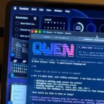 Terminal window showing Qwen Code working on a laptop