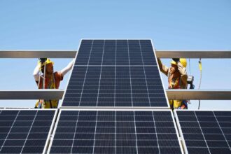 Rooftop solar panels and a home battery storing cheap electricity for peak-time selling