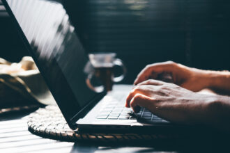 Person using a laptop with AI tools at the office