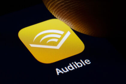 Person listening to an audiobook with headphones on a couch