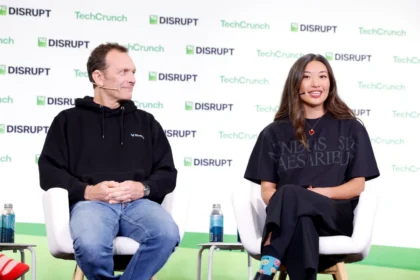 Audience member photographing the TechCrunch Disrupt stage where Bluesky introduced Attie expansion