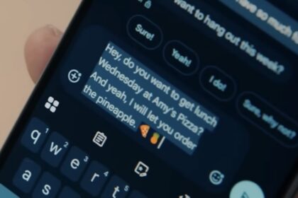 Person dictating a text message on an Android phone with the keyboard open