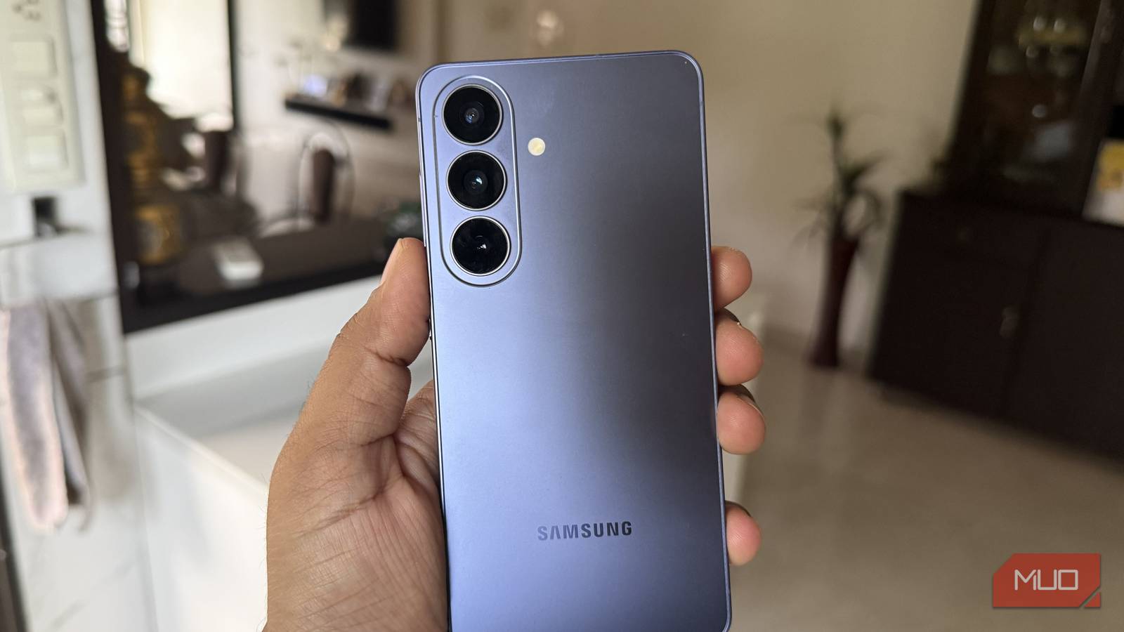 Hand holding a Samsung Galaxy S26 phone showing its notification panel
