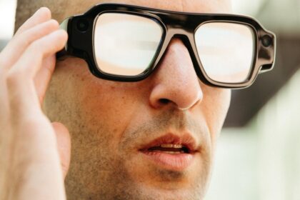 Person wearing the black Snap Specs AR glasses with thick frames