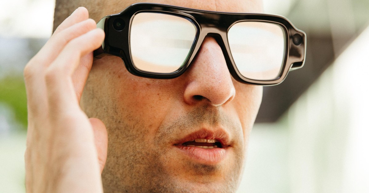 Person wearing the black Snap Specs AR glasses with thick frames