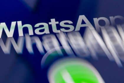Person holding a smartphone showing a chat app conversation
