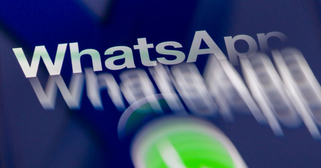 Person holding a smartphone showing a chat app conversation